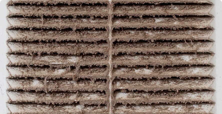 Dust buildup on an HVAC vent before cleaning