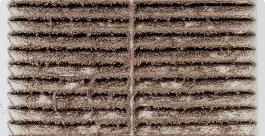 Dust buildup on an HVAC vent before cleaning